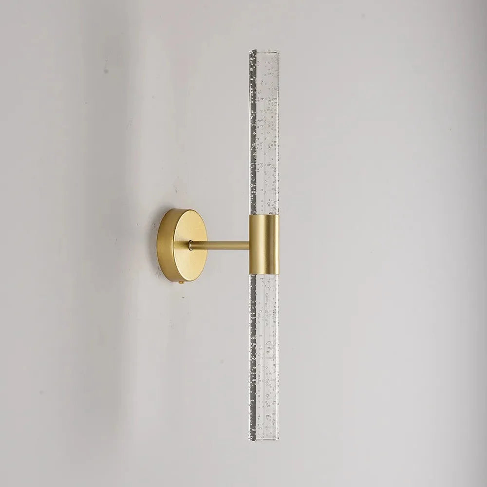 Bubble crystal rod wall sconce in brushed gold, unlit, on a pale wall