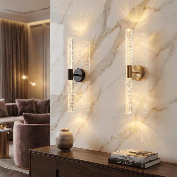 Black and gold crystal rod wall sconces on a marble wall above a console