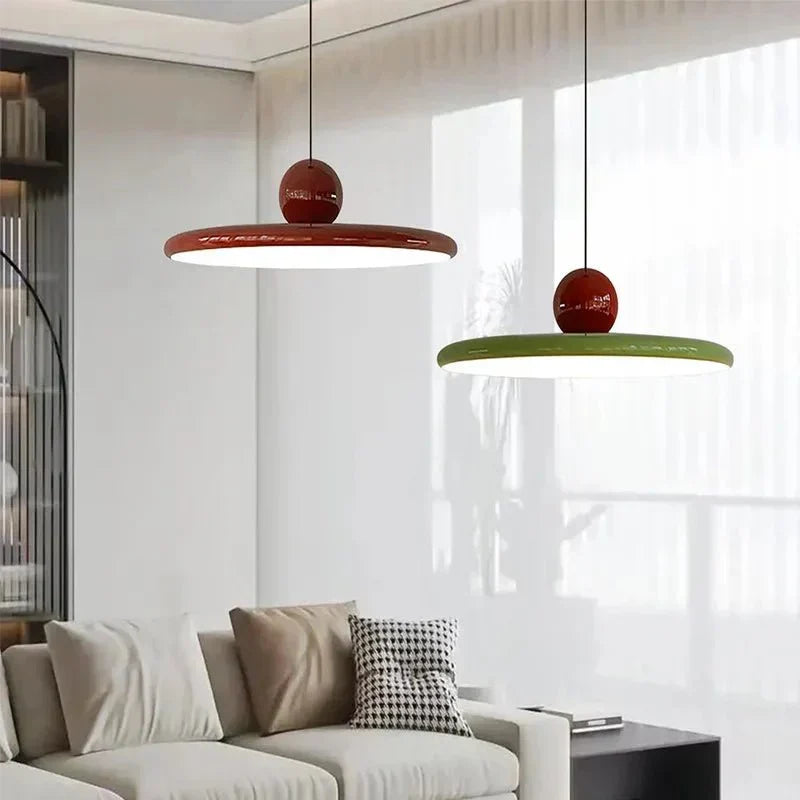 Red and green Ellis Bauhaus pendants in a living room