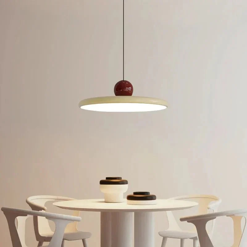 Ellis Bauhaus pendant with white shade over a round dining table