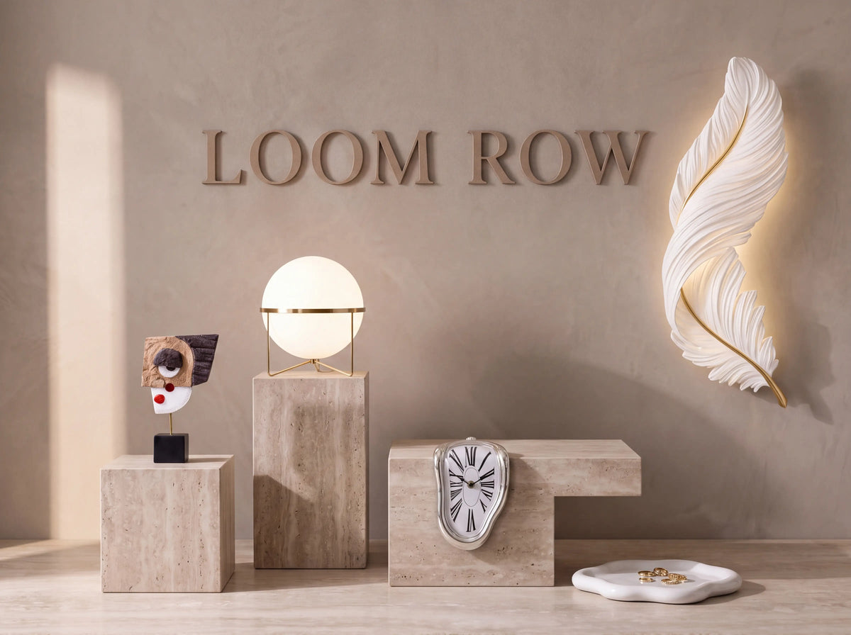 Loom Row lettering on a limewashed wall with lighting and objects on travertine plinths