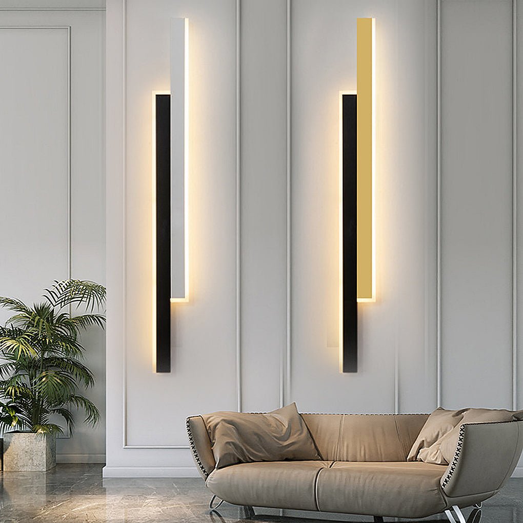 Vertis vertical LED wall lights in black with white and black with gold on a panelled living room wall